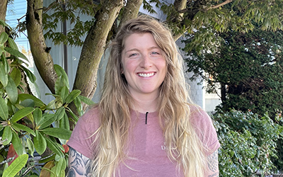 Woman smiling with trees in the background